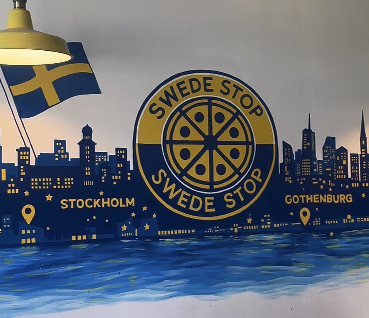 The hand-painted Swede Stop logo and skyline artwork inside the Hammersmith pizzeria
